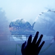 hand drawing heart on wet window